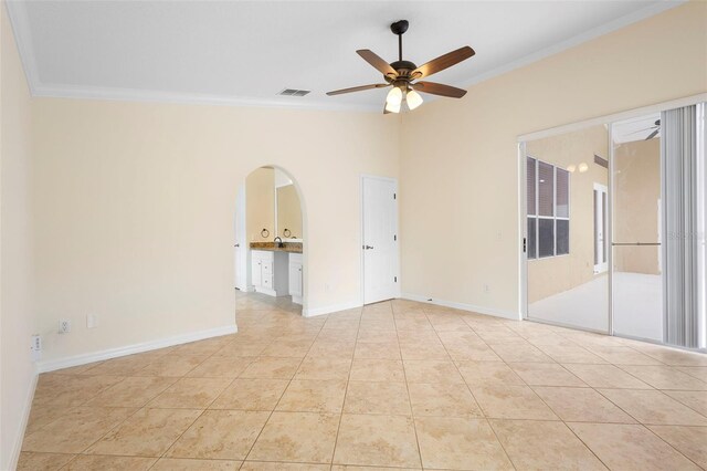 2263 Catbriar Way, Oviedo, FL 32765 - spare room with ornamental molding, ceiling fan, light tile patterned flooring, and arched walkways