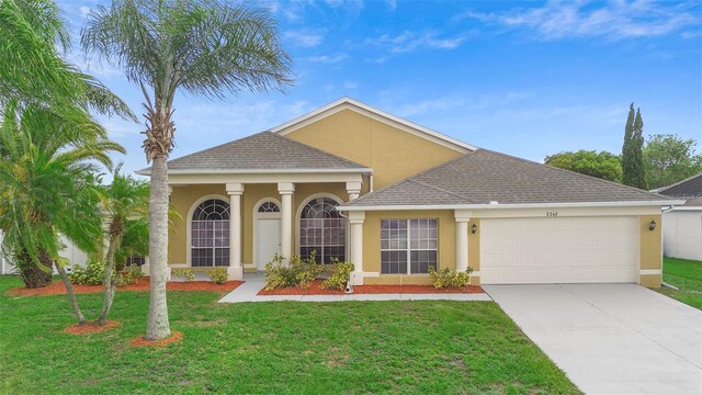 2263 Catbriar Way, Oviedo, FL 32765 - view of front of property featuring stucco siding, a garage, concrete driveway, a front yard, and roof with shingles