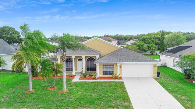 2263 Catbriar Way, Oviedo, FL 32765 - view of front of property featuring a garage, a front lawn, driveway, and stucco siding