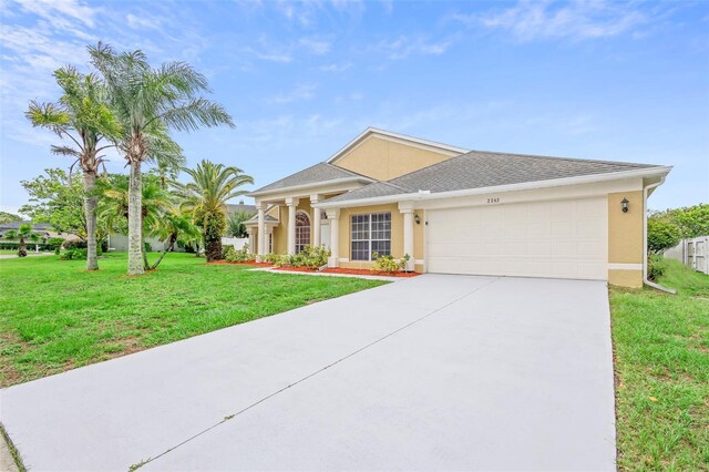 2263 Catbriar Way, Oviedo, FL 32765 - view of front facade featuring a garage, driveway, stucco siding, a front yard, and a shingled roof