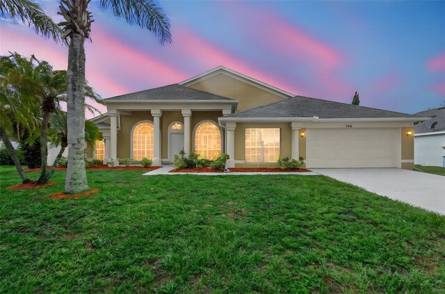 2263 Catbriar Way, Oviedo, FL 32765 - view of front facade featuring stucco siding, an attached garage, driveway, a yard, and roof with shingles