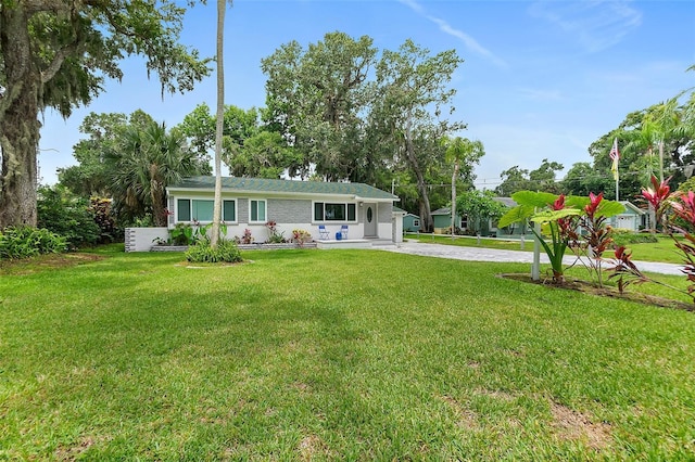812 Faulkner St, New Smyrna Beach, FL 32168 - view of front of house with a front yard and driveway