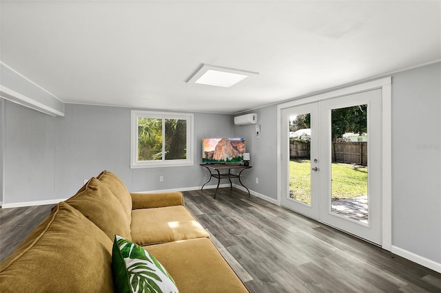 812 Faulkner St, New Smyrna Beach, FL 32168 - living area featuring french doors, an AC wall unit, wood finished floors, and a skylight
