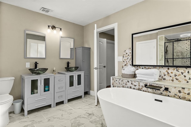 812 Faulkner St, New Smyrna Beach, FL 32168 - bathroom featuring marble finish flooring, a soaking tub, double vanity, and a stall shower