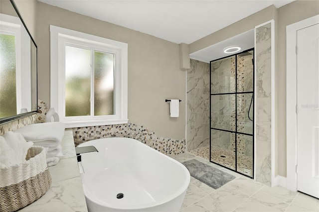 812 Faulkner St, New Smyrna Beach, FL 32168 - full bathroom featuring marble look tile flooring, a marble finish shower, plenty of natural light, and a soaking tub