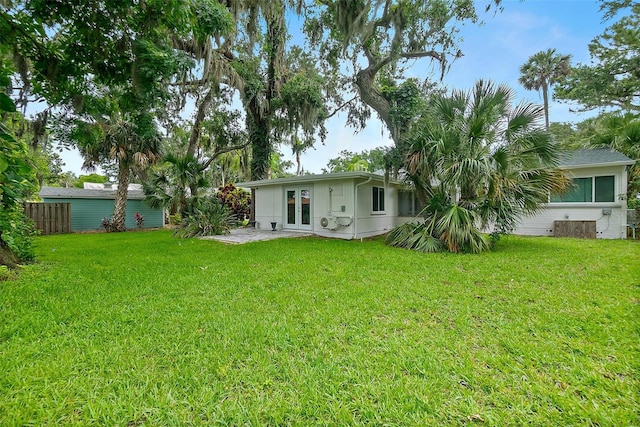 812 Faulkner St, New Smyrna Beach, FL 32168 - rear view of house with french doors and a lawn