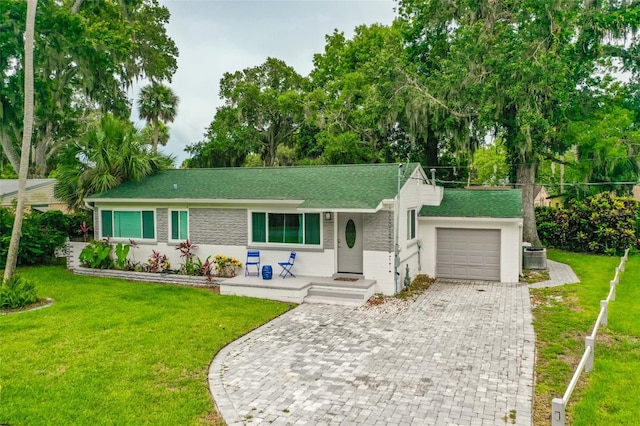 812 Faulkner St, New Smyrna Beach, FL 32168 - single story home featuring a garage, decorative driveway, a front yard, and a porch