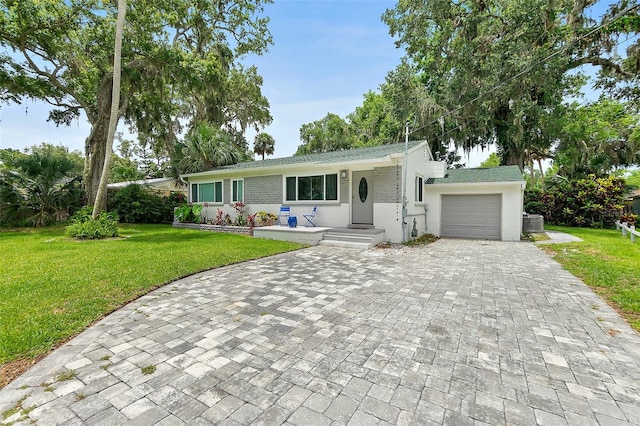 812 Faulkner St, New Smyrna Beach, FL 32168 - ranch-style home with decorative driveway, an attached garage, and a front lawn