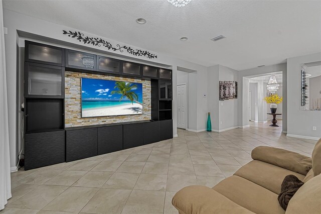 31 Abacus Ave, Ormond Beach, FL 32174 - living area with light tile patterned flooring, a textured ceiling, and built in shelves