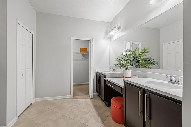 31 Abacus Ave, Ormond Beach, FL 32174 - full bathroom with two vanities, tile patterned floors, and a walk in closet