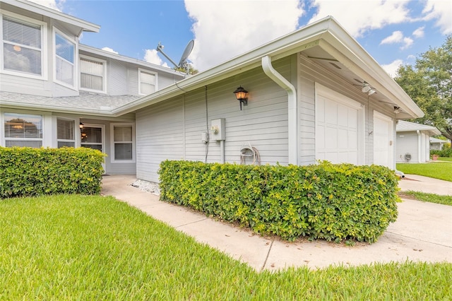 961 S Lakewood Ter Unit C, Port Orange, FL 32127 - view of side of property featuring a garage, a yard, and driveway