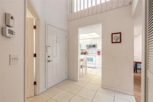 961 S Lakewood Ter Unit C, Port Orange, FL 32127 - entryway with light tile patterned floors and a high ceiling