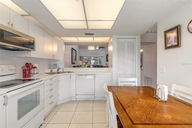 961 S Lakewood Ter Unit C, Port Orange, FL 32127 - kitchen featuring white appliances, light countertops, white cabinetry, and light tile patterned floors