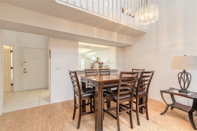 961 S Lakewood Ter Unit C, Port Orange, FL 32127 - dining room featuring light wood finished floors and a chandelier