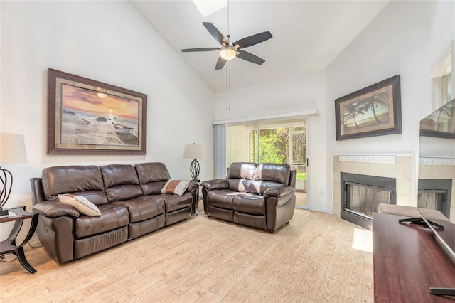 961 S Lakewood Ter Unit C, Port Orange, FL 32127 - living area featuring light wood-style floors, a ceiling fan, a fireplace, and high vaulted ceiling