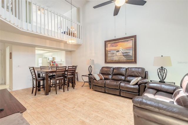 961 S Lakewood Ter Unit C, Port Orange, FL 32127 - living room featuring a high ceiling, light wood-type flooring, and a ceiling fan
