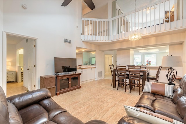 961 S Lakewood Ter Unit C, Port Orange, FL 32127 - living room with light wood-style floors, high vaulted ceiling, and ceiling fan