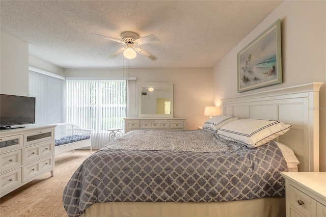 961 S Lakewood Ter Unit C, Port Orange, FL 32127 - bedroom featuring a textured ceiling, light wood finished floors, and a ceiling fan