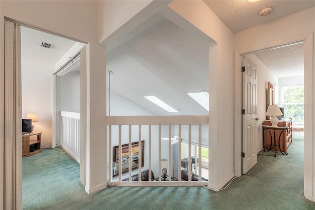 961 S Lakewood Ter Unit C, Port Orange, FL 32127 - hall with carpet floors, a textured ceiling, and a skylight