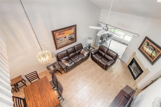 961 S Lakewood Ter Unit C, Port Orange, FL 32127 - living area with high vaulted ceiling, wood finished floors, a fireplace, and a ceiling fan