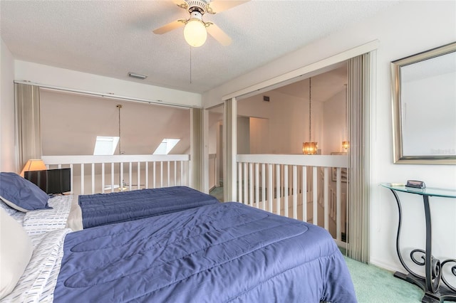 961 S Lakewood Ter Unit C, Port Orange, FL 32127 - carpeted bedroom featuring a skylight, a textured ceiling, and a ceiling fan
