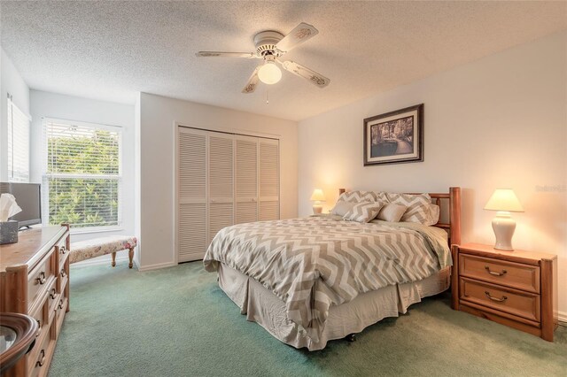 961 S Lakewood Ter Unit C, Port Orange, FL 32127 - bedroom featuring light colored carpet, a closet, a textured ceiling, and a ceiling fan