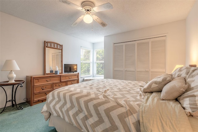 961 S Lakewood Ter Unit C, Port Orange, FL 32127 - carpeted bedroom with a closet, a textured ceiling, and a ceiling fan