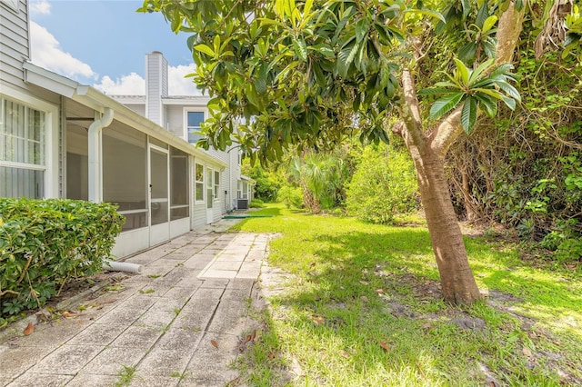 961 S Lakewood Ter Unit C, Port Orange, FL 32127 - view of grassy yard featuring a sunroom and a patio