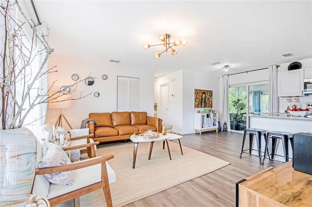 1455 Whitewood Dr, Deltona, FL 32725 - living area featuring light wood-type flooring and a chandelier