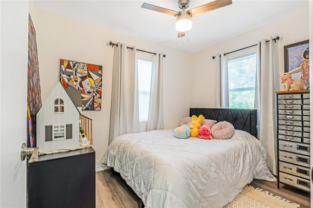 1455 Whitewood Dr, Deltona, FL 32725 - bedroom with wood finished floors, multiple windows, and a ceiling fan