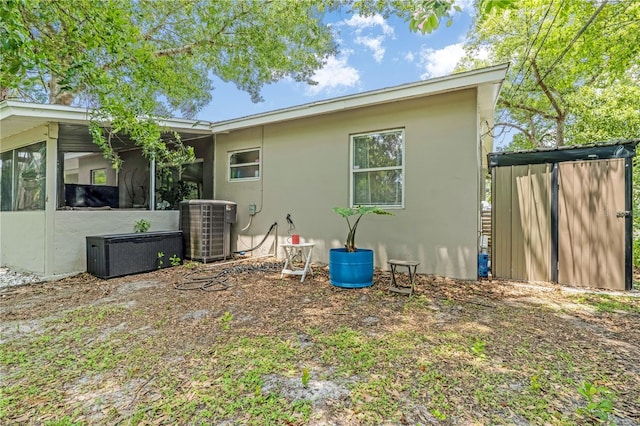 1455 Whitewood Dr, Deltona, FL 32725 - back of property with stucco siding and a sunroom