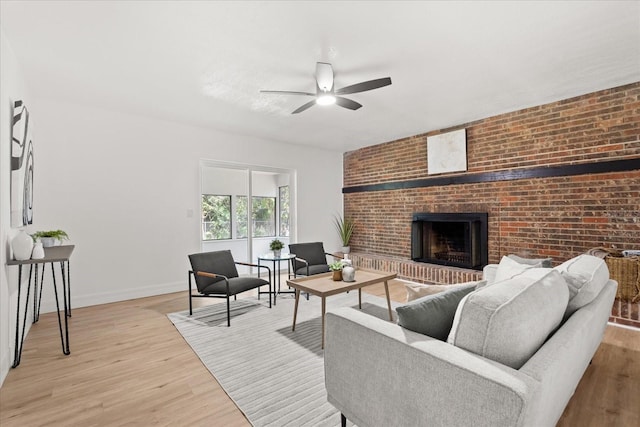 3655 Scott St, Port Orange, FL 32129 - living area with ceiling fan, light wood finished floors, a fireplace, and brick wall