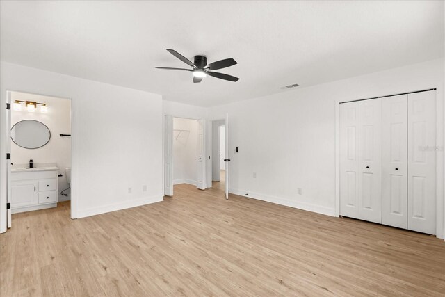3655 Scott St, Port Orange, FL 32129 - unfurnished bedroom with light wood-type flooring, ensuite bath, and a ceiling fan