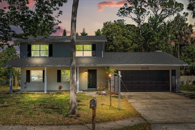 3655 Scott St, Port Orange, FL 32129 - traditional home with an attached garage, concrete driveway, a lawn, and brick siding