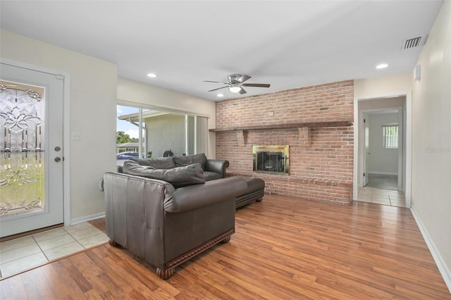 502 W Hogle Ave, Deland, FL 32720 - living room with ceiling fan, wood finished floors, a fireplace, plenty of natural light, and recessed lighting