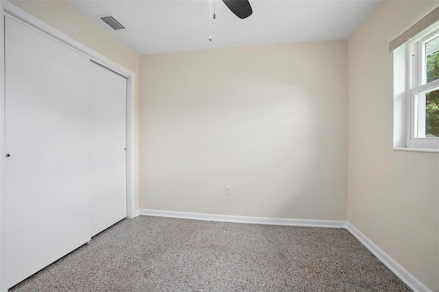 502 W Hogle Ave, Deland, FL 32720 - unfurnished bedroom with speckled floor, ceiling fan, and a closet