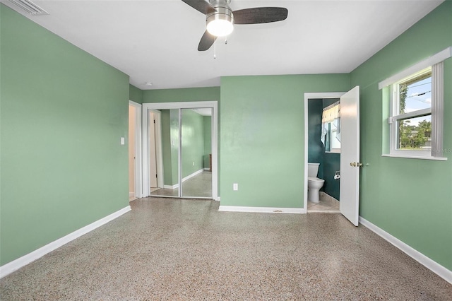 502 W Hogle Ave, Deland, FL 32720 - unfurnished bedroom with speckle patterned floor, a closet, ensuite bath, and ceiling fan