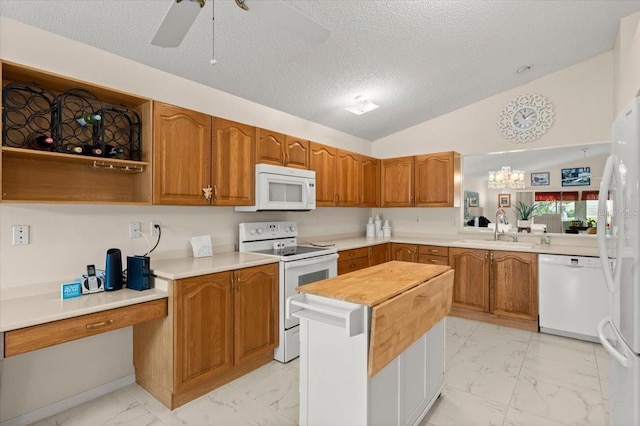 123 Wood Ibis Ct, Daytona Beach, FL 32119 - kitchen with white appliances, light marble finish floors, a textured ceiling, brown cabinetry, and ceiling fan