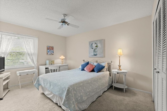 123 Wood Ibis Ct, Daytona Beach, FL 32119 - bedroom with light carpet, a textured ceiling, a ceiling fan, and a closet