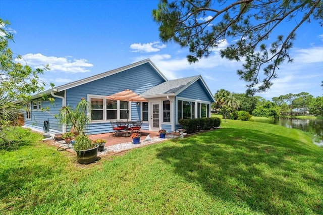 123 Wood Ibis Ct, Daytona Beach, FL 32119 - back of house featuring a patio, a yard, and a water view