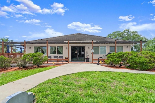 123 Wood Ibis Ct, Daytona Beach, FL 32119 - back of property with a yard, stucco siding, and french doors
