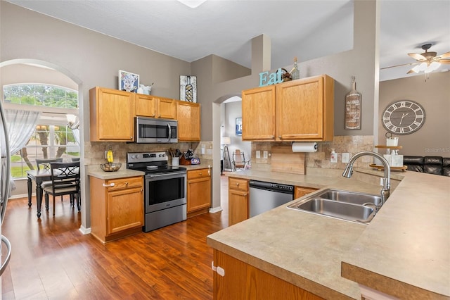 3 Kanawha Ct, Palm Coast, FL 32164 - kitchen featuring stainless steel appliances, arched walkways, ceiling fan, dark wood-style floors, and decorative backsplash