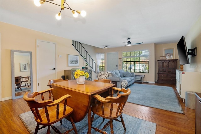 874 Commonwealth Ct, Casselberry, FL 32707 - dining area with stairs, wood finished floors, ceiling fan, and a chandelier