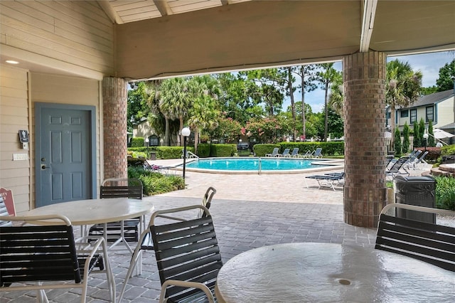 874 Commonwealth Ct, Casselberry, FL 32707 - view of patio / terrace featuring outdoor dining space and a community pool
