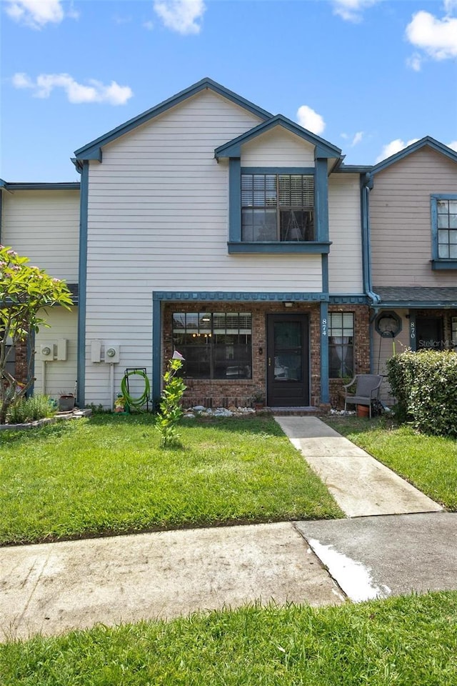 874 Commonwealth Ct, Casselberry, FL 32707 - view of property with a front lawn and brick siding