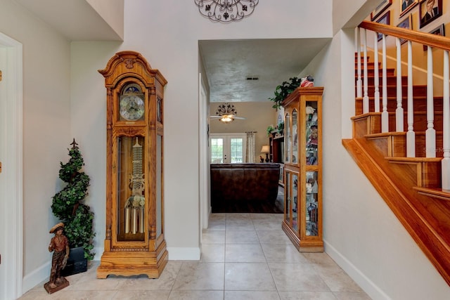1383 Tumblin Dr, New Smyrna Beach, FL 32168 - tiled entrance foyer with stairway and baseboards