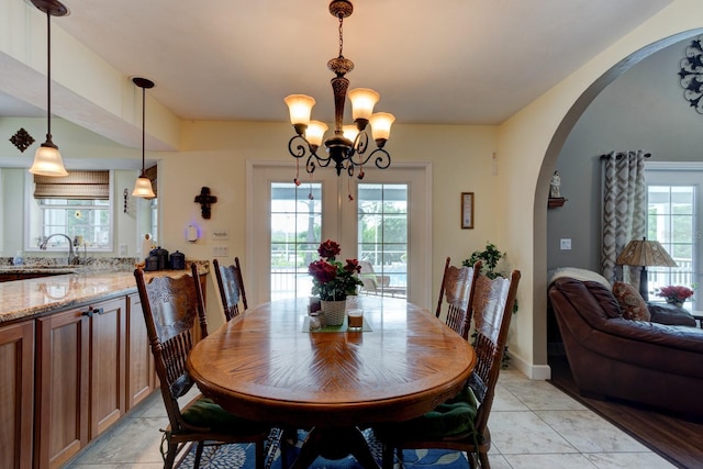 1383 Tumblin Dr, New Smyrna Beach, FL 32168 - dining space featuring arched walkways and a chandelier
