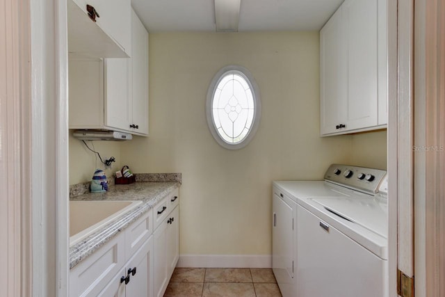 1383 Tumblin Dr, New Smyrna Beach, FL 32168 - laundry room with washer and clothes dryer, cabinet space, and light tile patterned floors