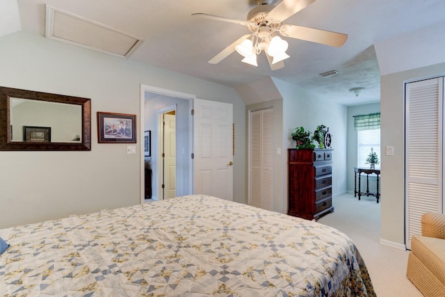 1383 Tumblin Dr, New Smyrna Beach, FL 32168 - carpeted bedroom featuring two closets, a ceiling fan, attic access, and vaulted ceiling