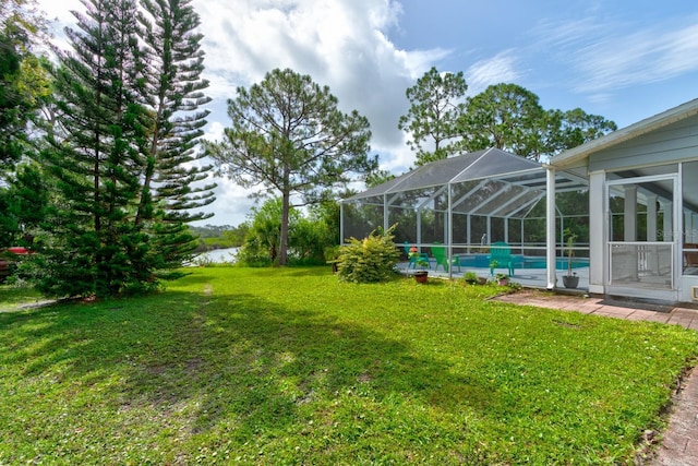 1383 Tumblin Dr, New Smyrna Beach, FL 32168 - view of green lawn with an outdoor pool and glass enclosure